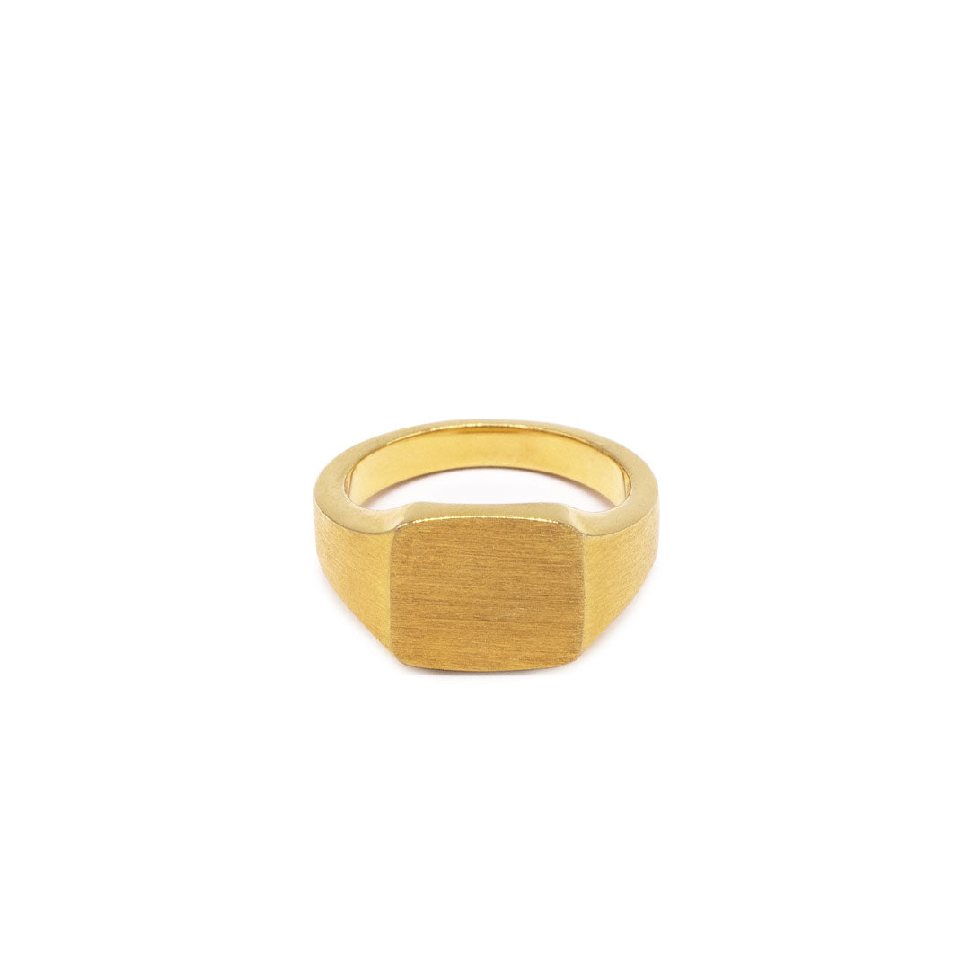 Gold plated Silver ring with a square face and a heavily brushed finishon a white background