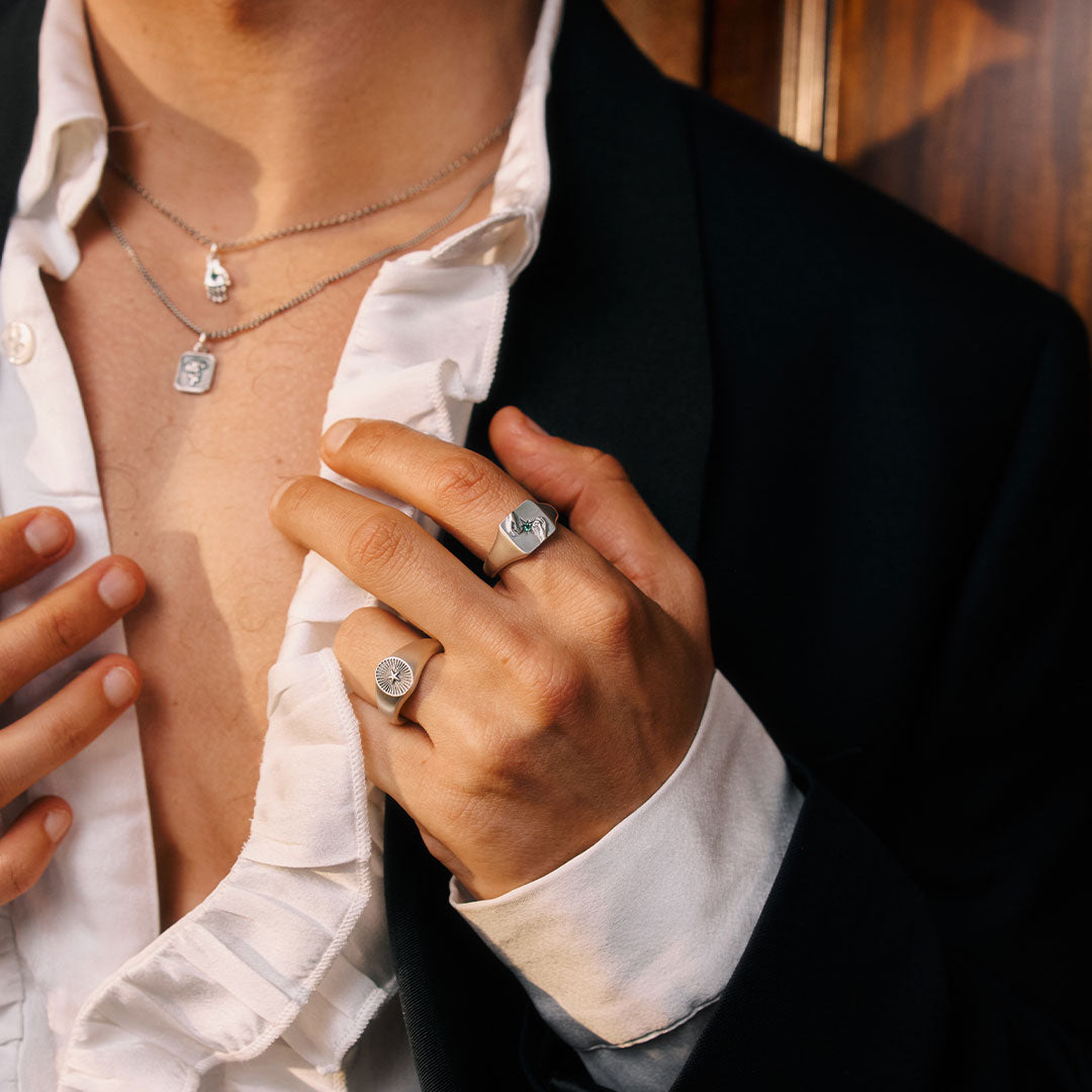 Close-up of a person wearing silver rings with a blurred background