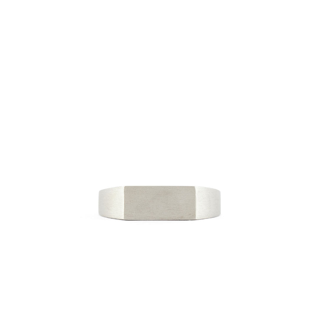 Silver ring with a Rectangle shaped face and heavy brushed finish on a white background