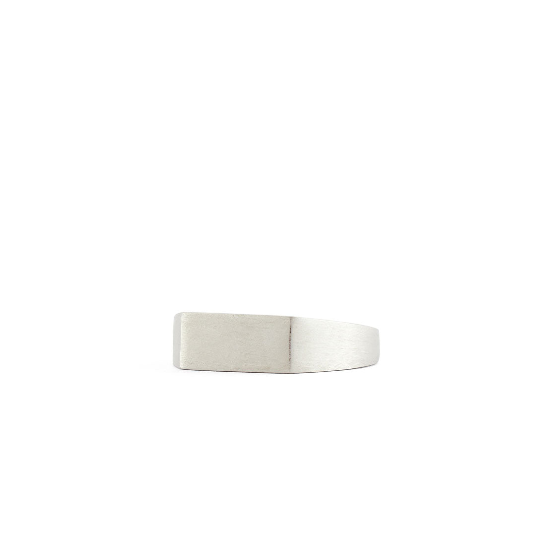 Silver ring with a Rectangle shaped face and heavy brushed finish on a white background