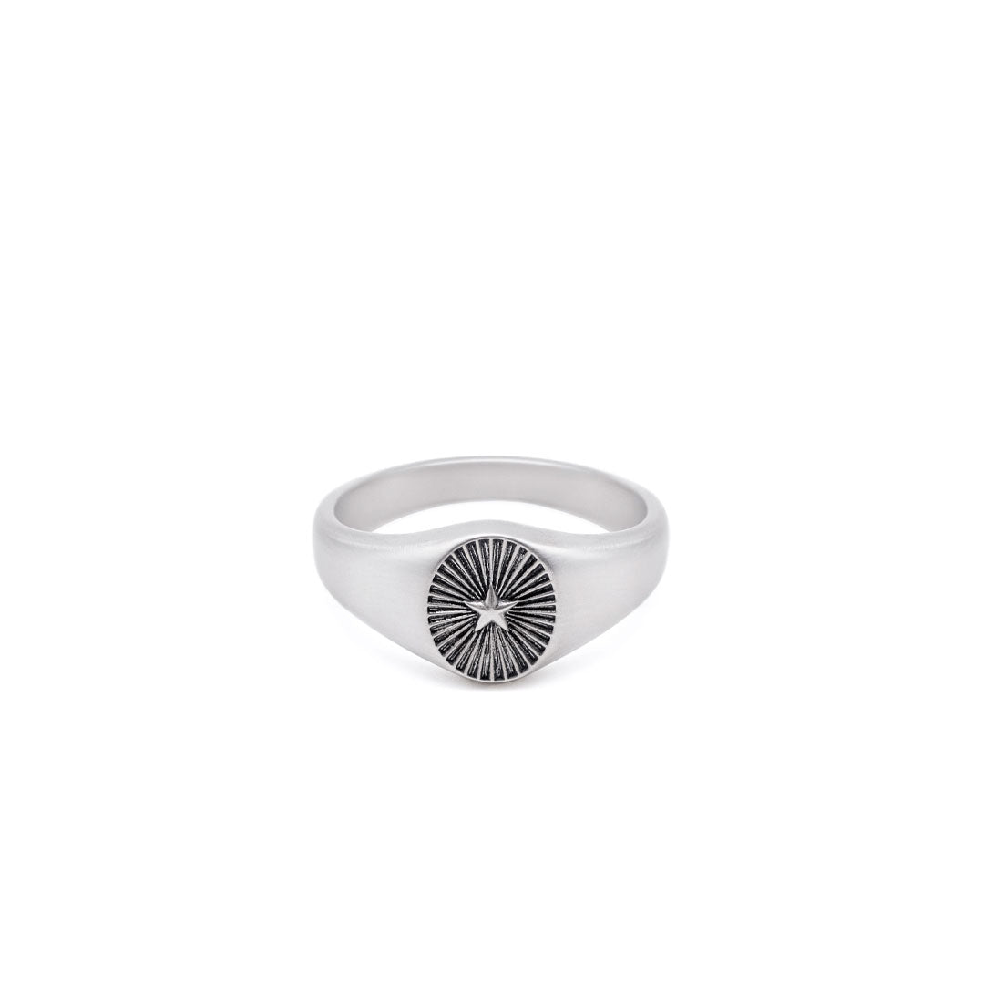 Silver signet ring with a star & ridged background by Serge DeNimes