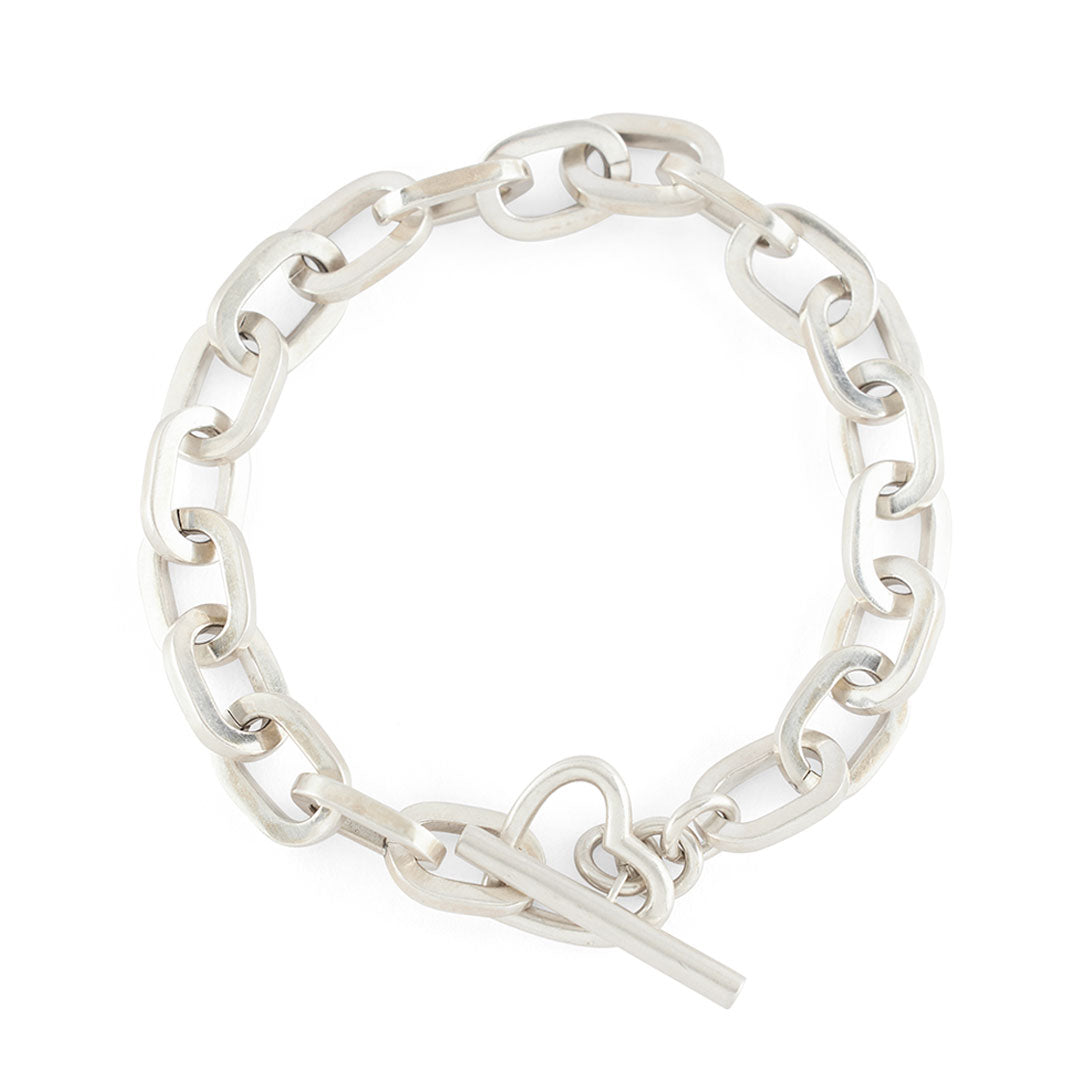 Silver thick chain bracelet with oval links and a t bar closing function on a white background