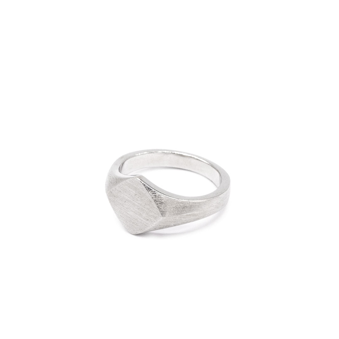 Silver ring with a Rhombus shaped face and heavy brushed finish on a white background